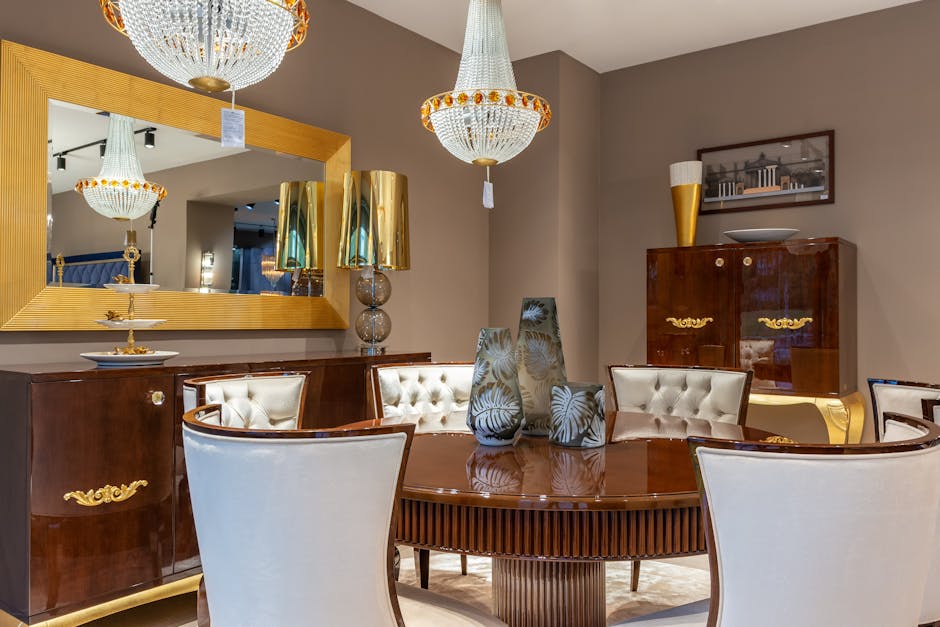 Decorative vases on round wooden table near mirror with lamps and cabinet in spacious room with vintage design in apartment